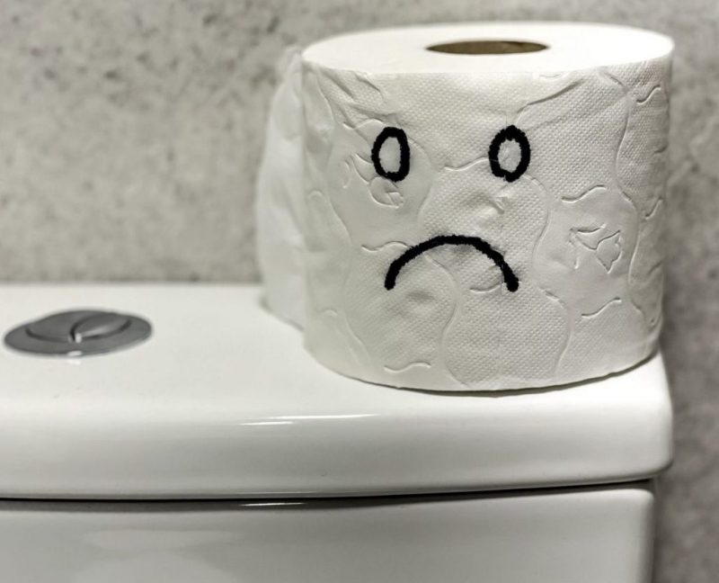 Sad,Face,Painted,On,Toilet,Paper,Roll.,Concept,Of,Constipation